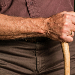 Person holding a cane.
